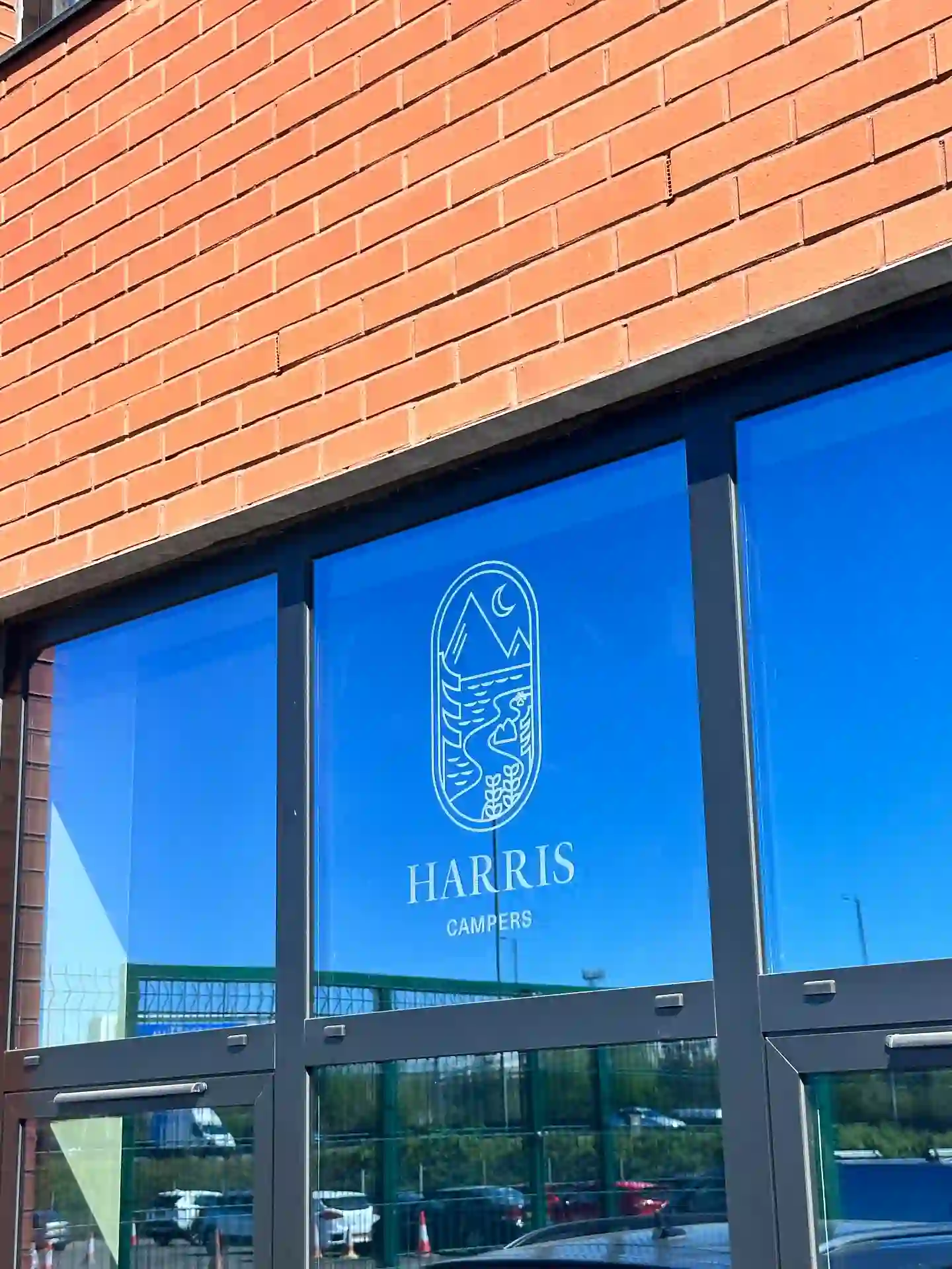 Cut vinyl window graphics, logo and wordmark to showroom glazing — Harris Campers, commercial signage by L4 Signs Glasgow