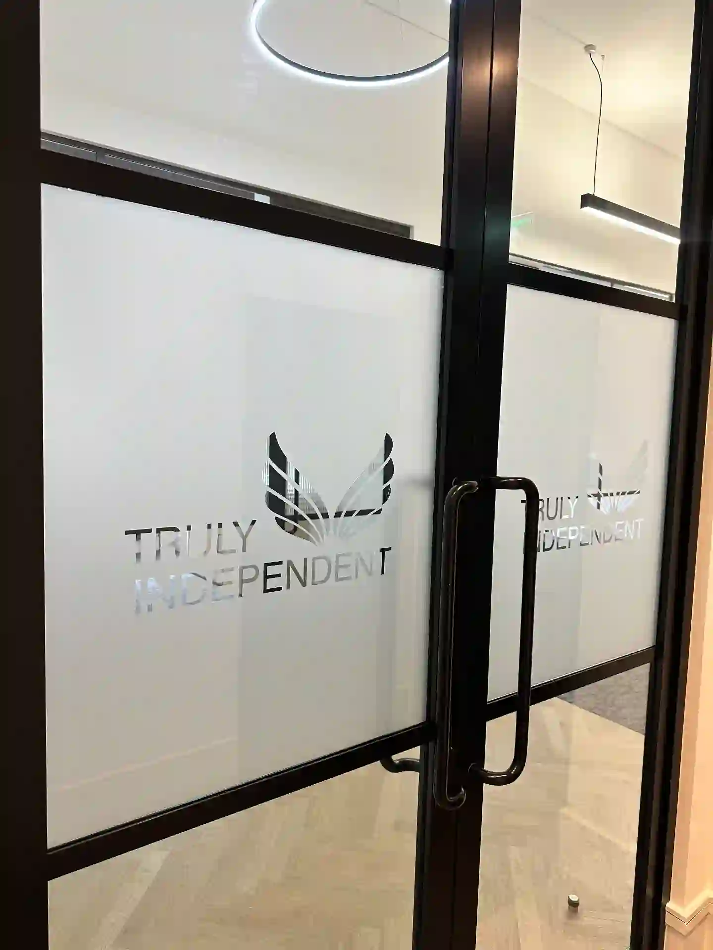 Frosted manifestation with cut logotype, reeded privacy film to glazed partitions — Truly Independent, commercial signage by L4 Signs Glasgow