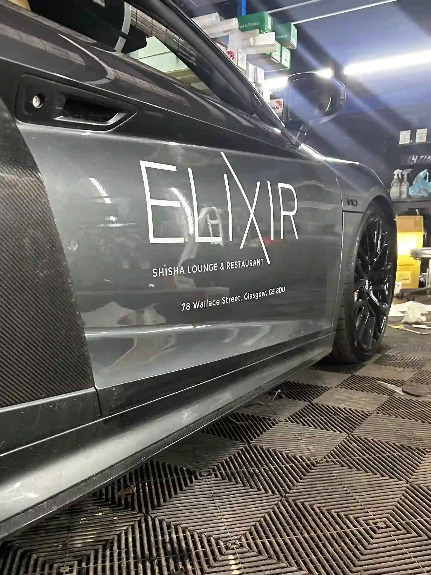White cut vinyl ELIXIR Shisha Lounge & Restaurant door graphics with Wallace Street Glasgow address applied to a grey Audi R8
