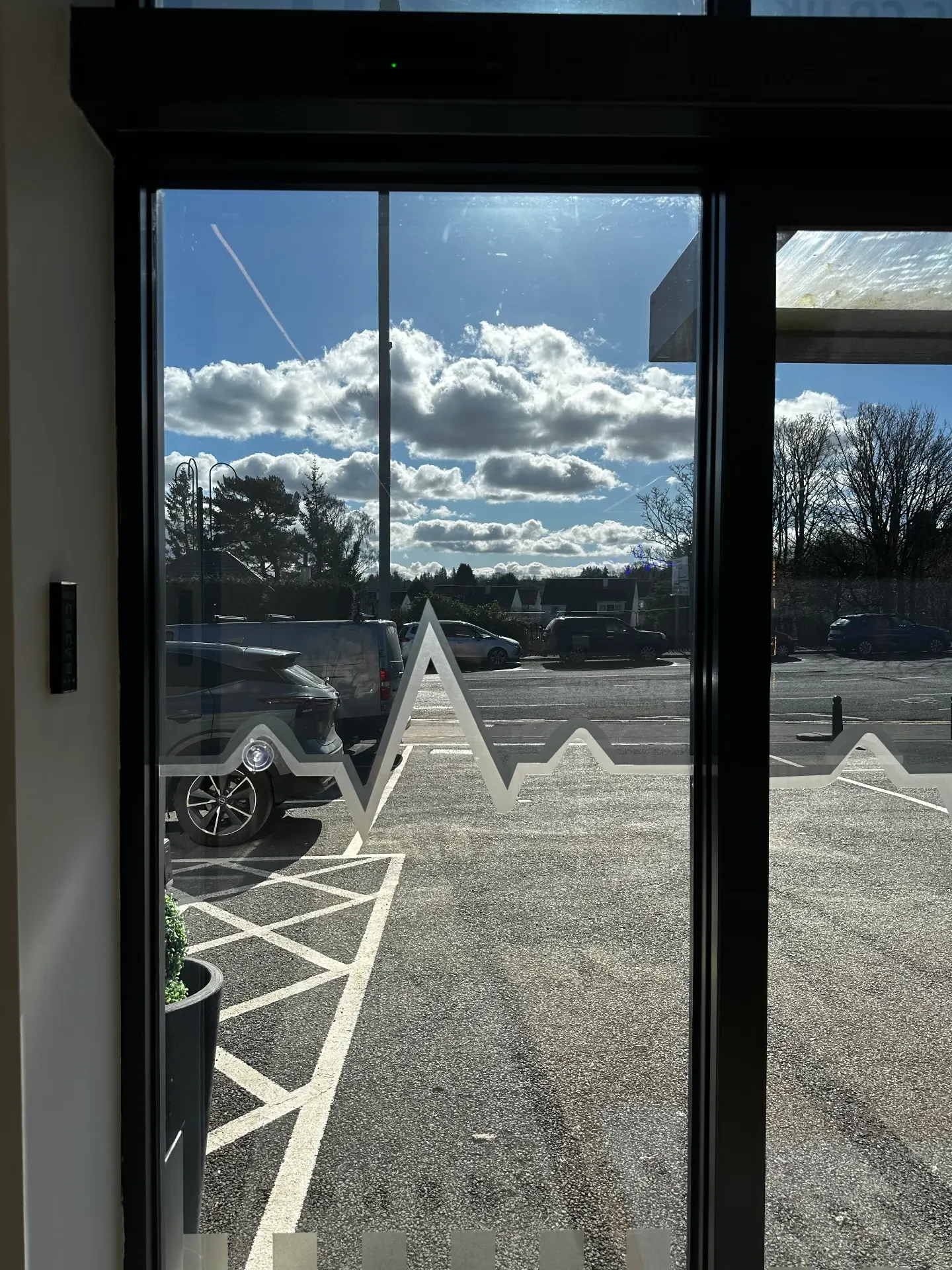 Close-up of the frosted heartbeat manifestation on clinic glazing with glare reduction film cut to follow the trace